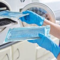 Female nurse doing sterilization of dental medical instruments in autoclave. Sterilization department at dental clinic