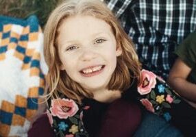 smiling girl on blanket
